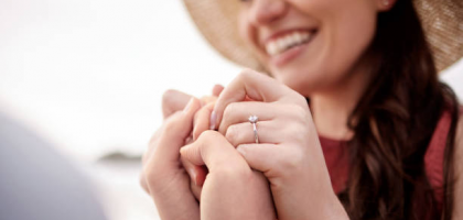 A woman holding a promise ring, ready to have a meaningful conversation with her partner.
